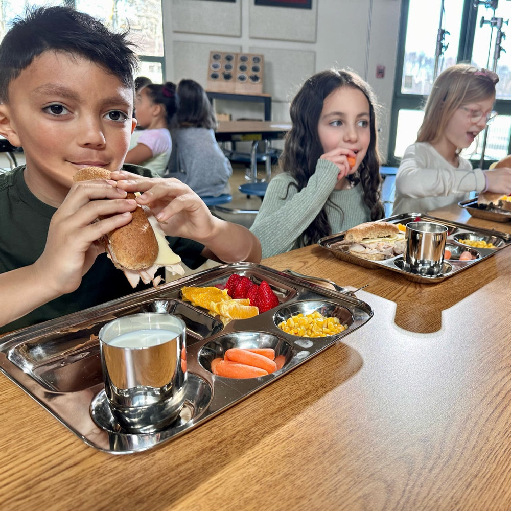Kids enjoying balanced meals on pediatrician-designed stainless steel trays